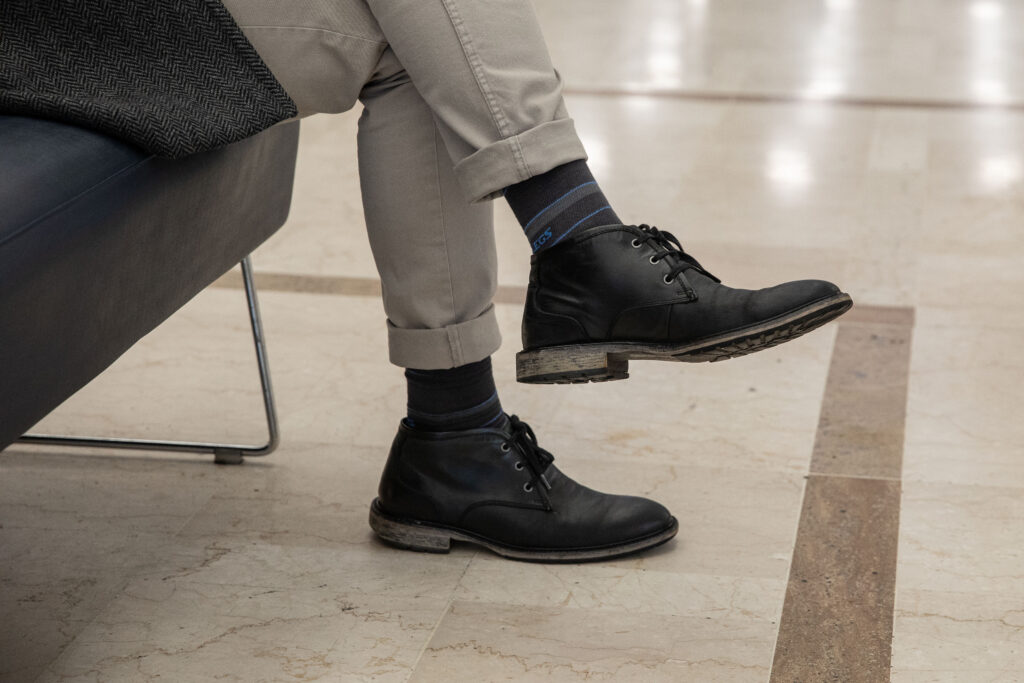 Man waiting at airport wearing Fitlegs compression socks